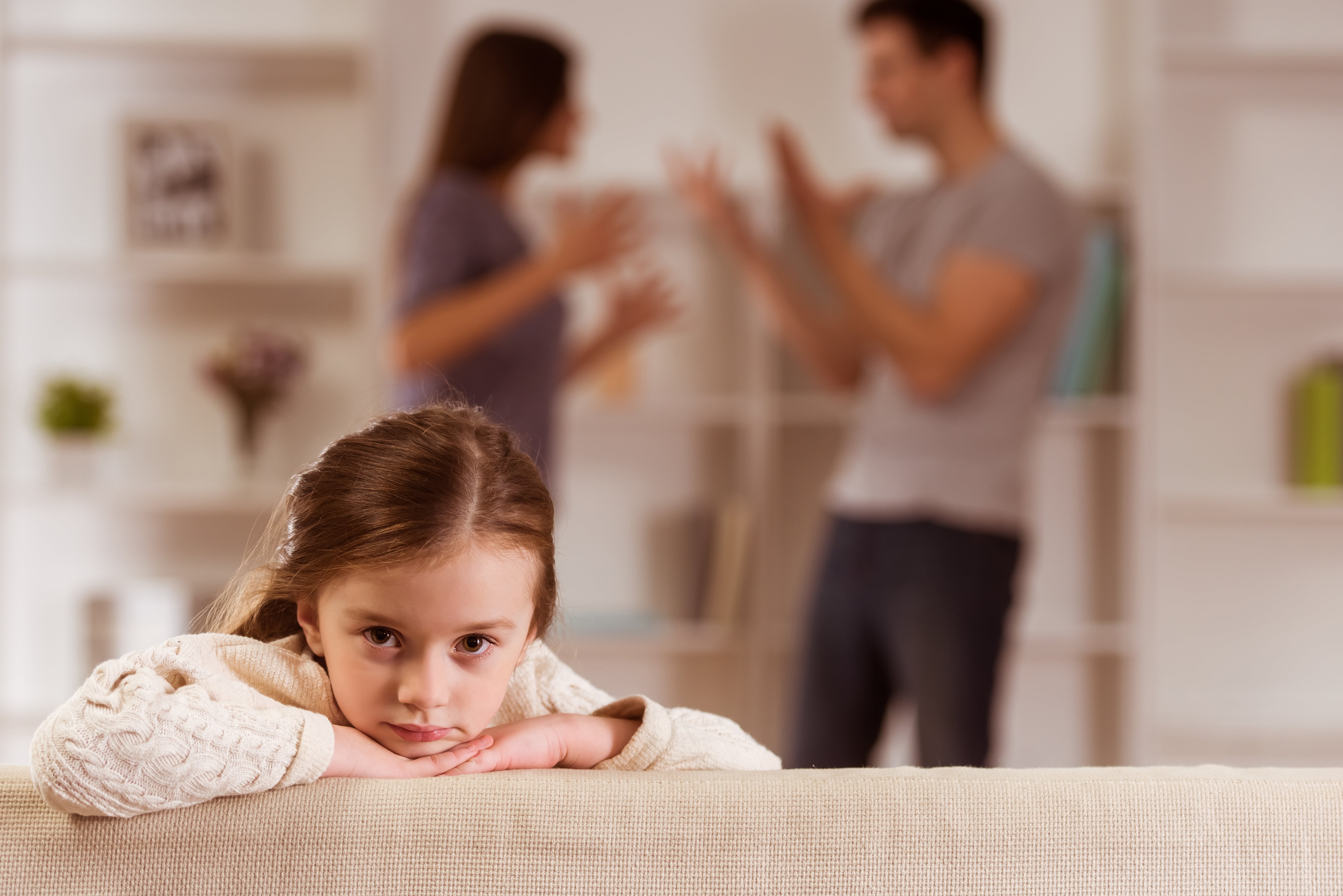 little girl with parents arguing